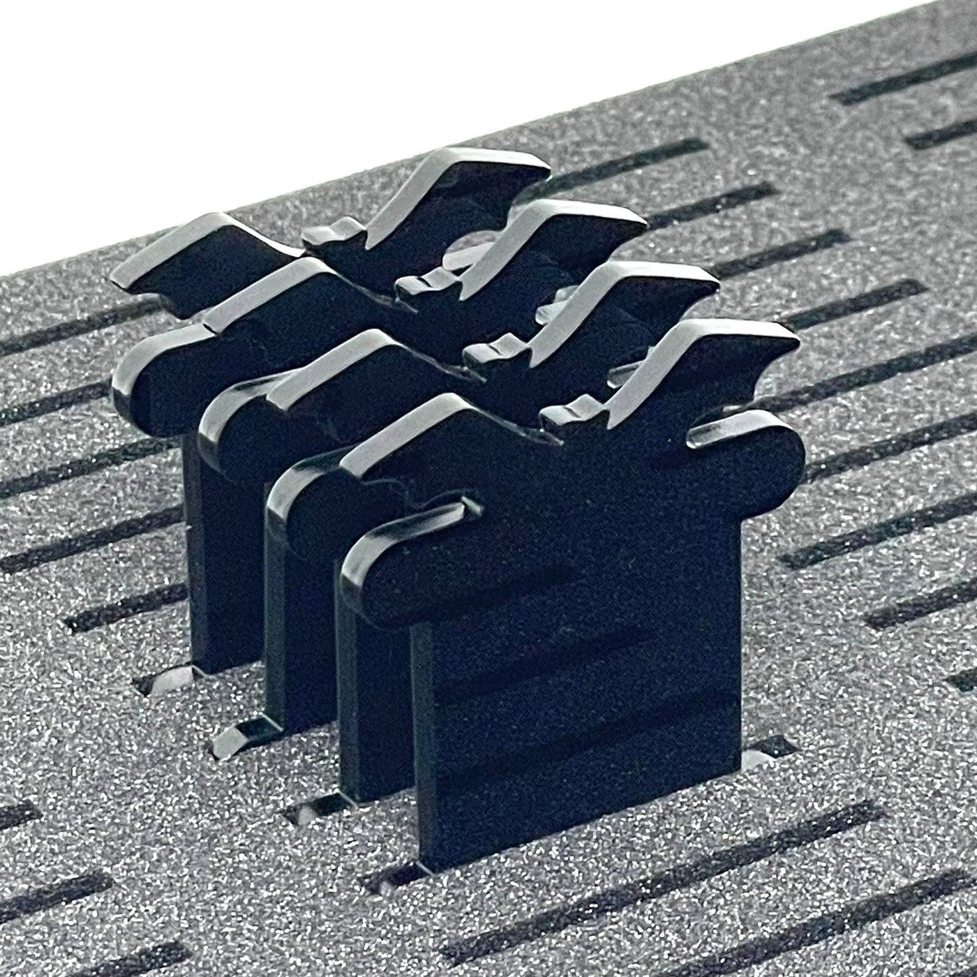 Black Bat shaped acrylic bobbins for embroidery floss stood in foam insert 