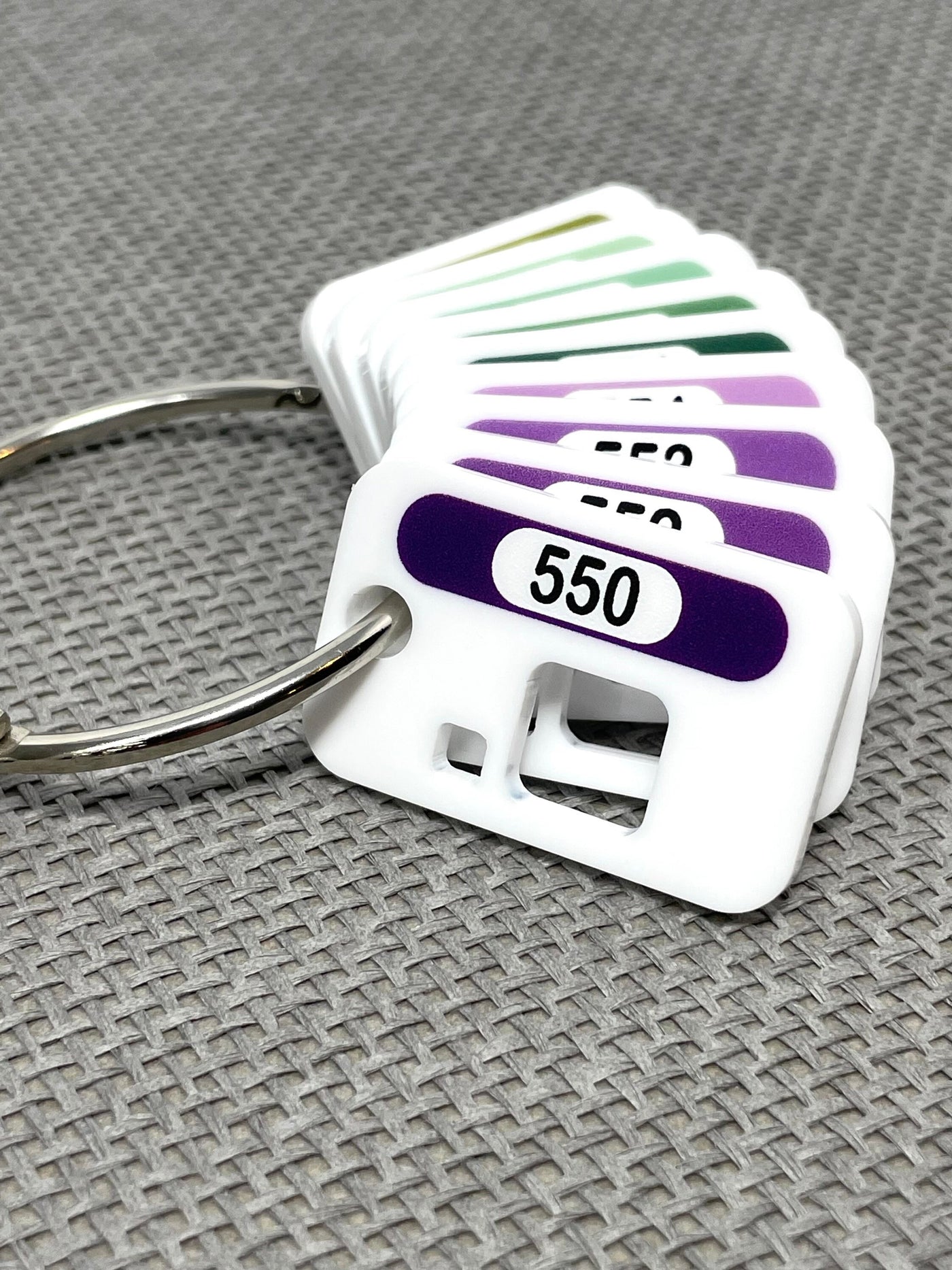 Acrylic floss drops by Pip and Chip with printed DMC number and colour swatch on a metal binder ring