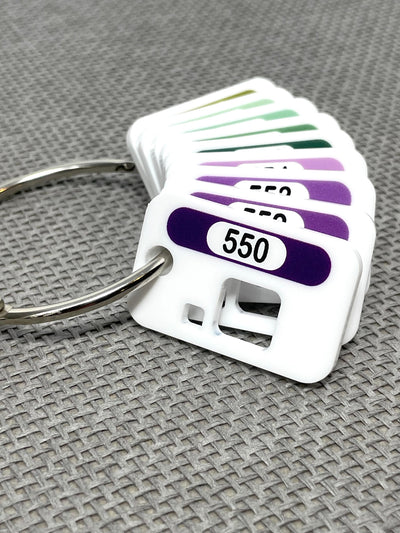 Acrylic floss drops by Pip and Chip with printed DMC number and colour swatch on a metal binder ring