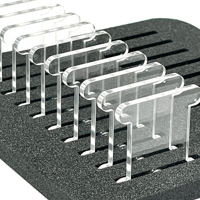 Set of clear acrylic floss storage bobbins stood upright in foam insert by Pip and Chip