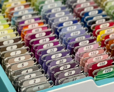 DMC floss wrapped on clear acrylic bobbins – Pip & Chip embroidery organisation setup