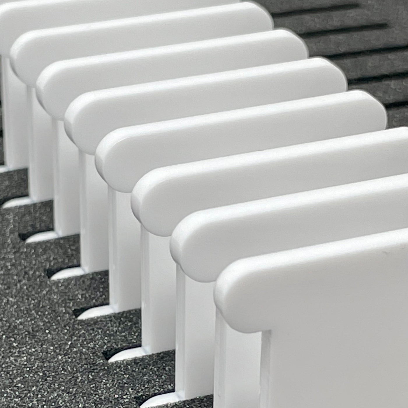 White acrylic bobbins stood in foam insert for organising cross stitch floss by Pip and chip